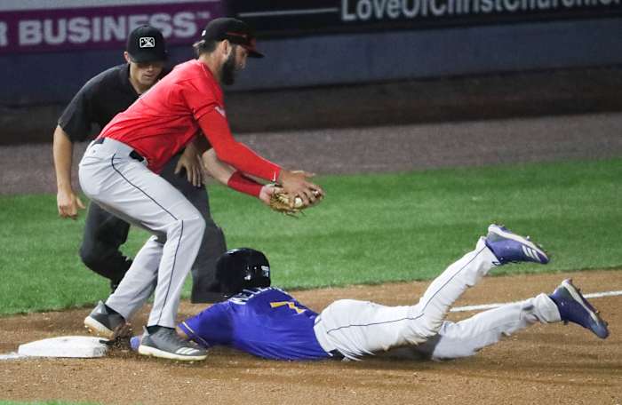 Wilmington's MJ Melendez slides safely into third as he advances on a sacrifice fly under the tag of Fayetteville's David Hensley in the seventh inning of the Blue Rocks' 3-1 loss in the opening game of the Mills Cup Championship Series Tuesday at Frawley Stadium. Fayetteville 3 Rocks 1 Mandatory Credit: © WILLIAM BRETZGER, DELAWARE NEWS JOURNAL, Delaware News Journal via Imagn Content Services, LLC